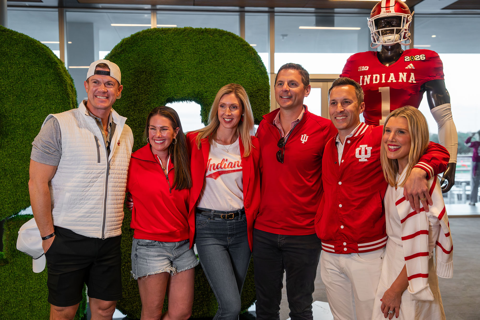 A group of guests posing together at a Playoff Premium pregame event
