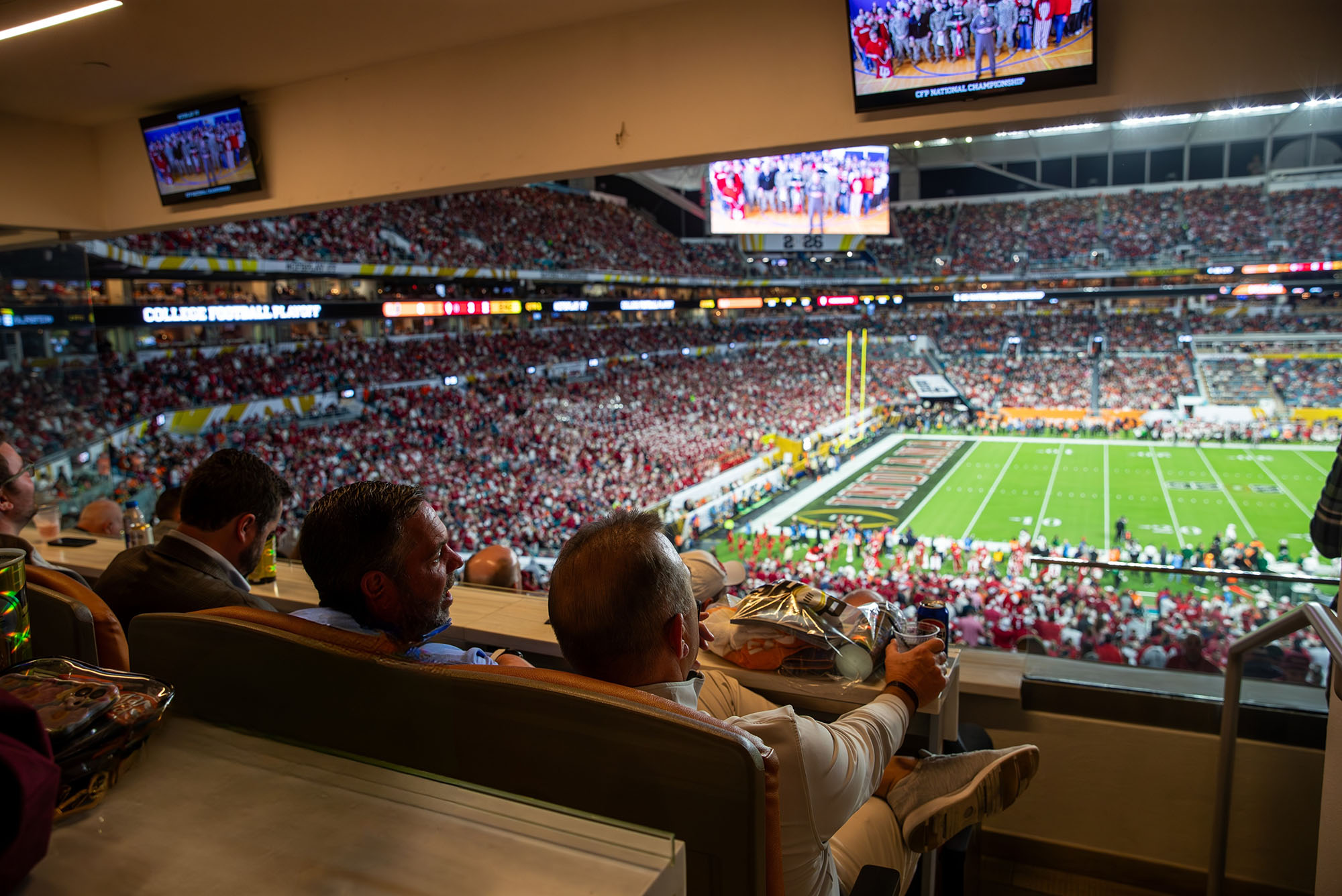 Guests watching the National Championship from a stadium suite